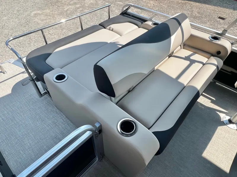 Slide: The Image of The image shows a luxurious seating area on a boat with beige and black upholstery. - 16