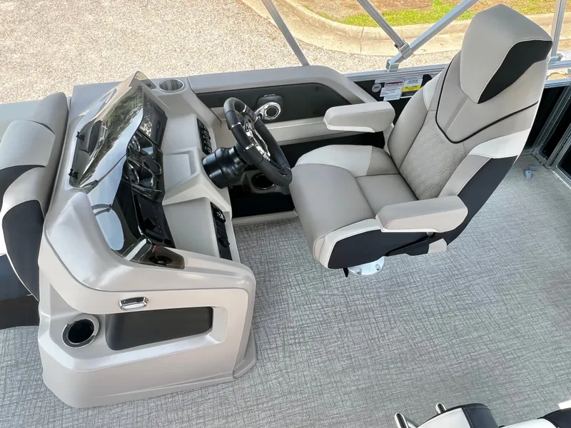 Slide: The Image of The image shows the helm of an Avalon LSZ 25' Entertainer with a sleek captain's chair and modern controls. - 13