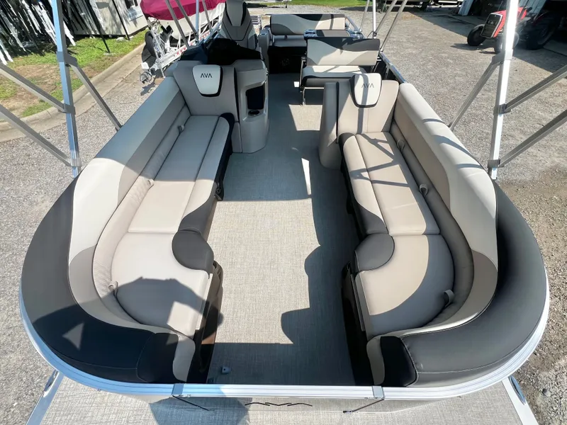 Slide: The Image of The image shows the interior of an Avalon LSZ 25' Entertainer pontoon boat with sleek, cushioned seating. - 8