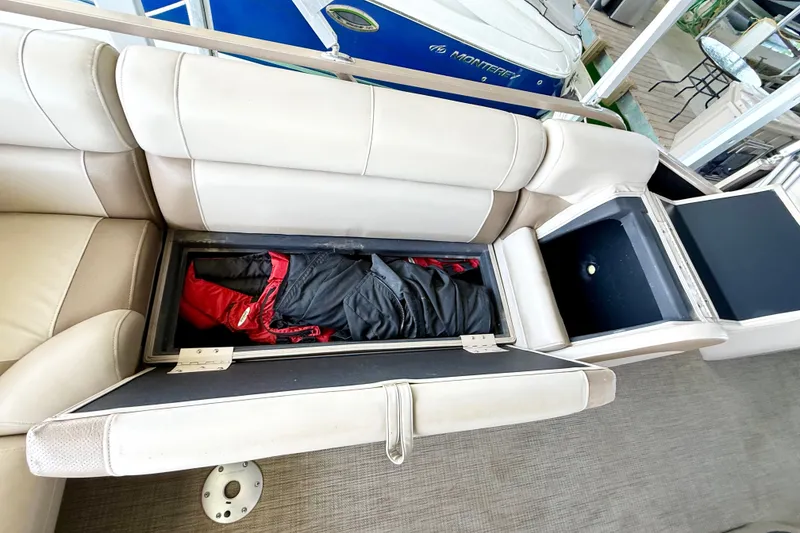 Slide: The Image of 2017 Bentley Pontoons 223 Elite Cruise with open storage compartments and beige seating. - 26