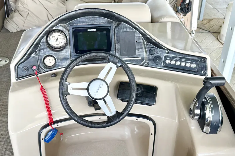 Slide: The Image of 2017 Bentley Pontoons 223 Elite Cruise dashboard with steering wheel and controls. - 23
