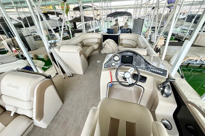 Slide: The Image of 2017 Bentley Pontoons 223 Elite Cruise interior with luxurious seating and modern dashboard. - 22