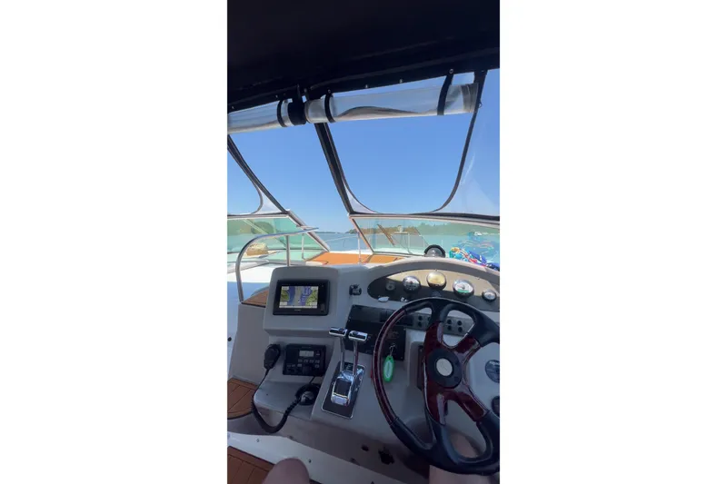 Slide: The Image of Cockpit view of 2003 Cruisers Yachts 3372 Express with navigation equipment. - 24