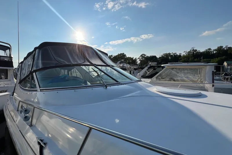 Slide: The Image of 2003 Cruisers Yachts 3372 Express docked under a clear blue sky. - 11