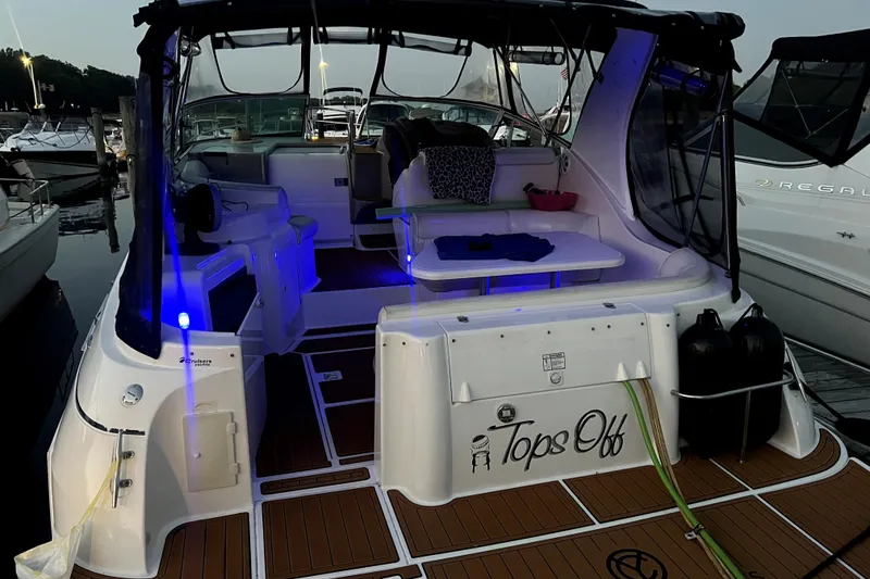 Slide: The Image of 2003 Cruisers Yachts 3372 Express at dock, illuminated interior, evening setting. - 27