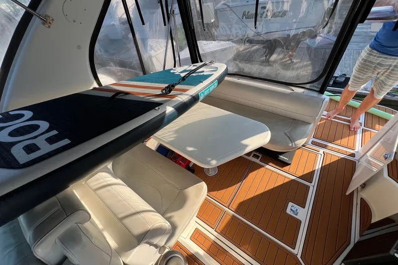 Slide: The Image of 2003 Cruisers Yachts 3372 Express interior with paddleboard and seating area. - 49