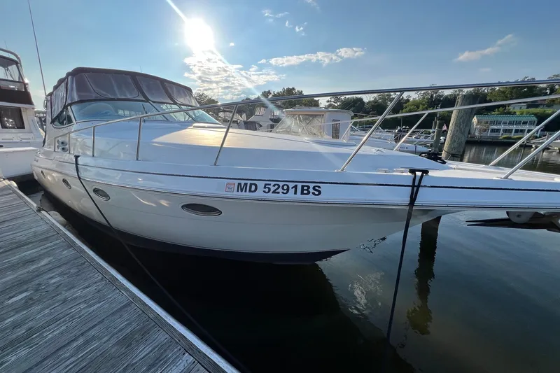 The Image of 2003 Cruisers Yachts 3372 Express docked at marina under sunny sky. - 0