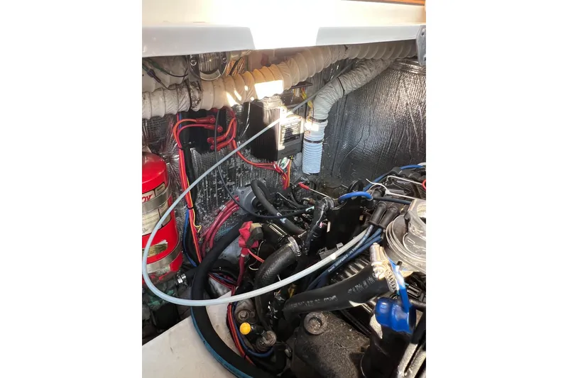 Slide: The Image of Engine compartment of 2003 Cruisers Yachts 3372 Express with visible wiring and components. - 15