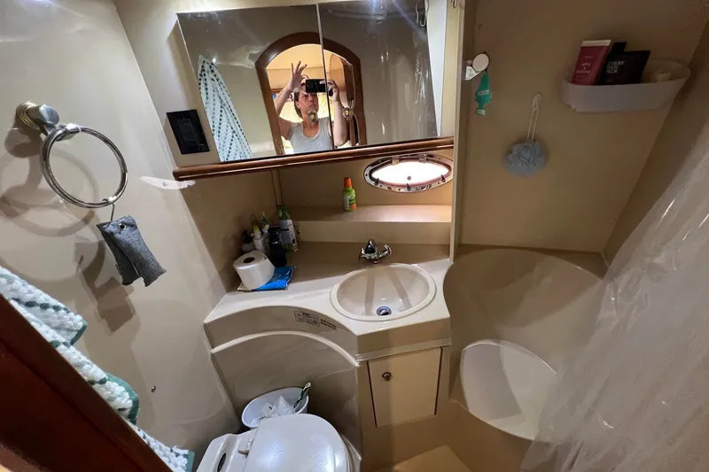 Slide: The Image of Bathroom interior of 2003 Cruisers Yachts 3372 Express, featuring sink and mirror. - 37