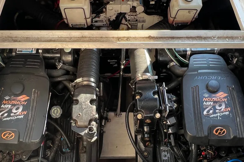 Slide: The Image of Engine compartment of a 2003 Cruisers Yachts 3372 Express, featuring twin Mercury engines. - 3