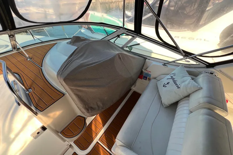 Slide: The Image of 2003 Cruisers Yachts 3372 Express interior with cushioned seating and wooden flooring. - 48