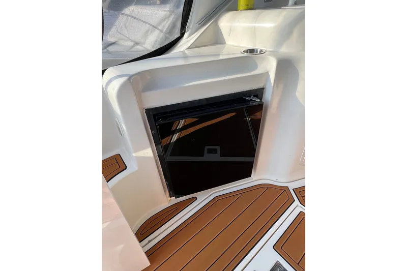Slide: The Image of 2003 Cruisers Yachts 3372 Express interior with wood flooring and built-in mini fridge. - 52