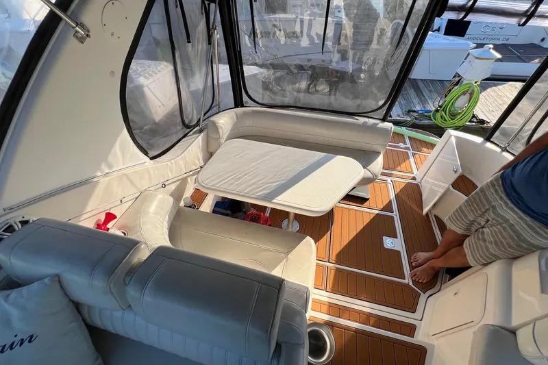 Slide: The Image of Interior of 2003 Cruisers Yachts 3372 Express with seating and table on wooden deck. - 47