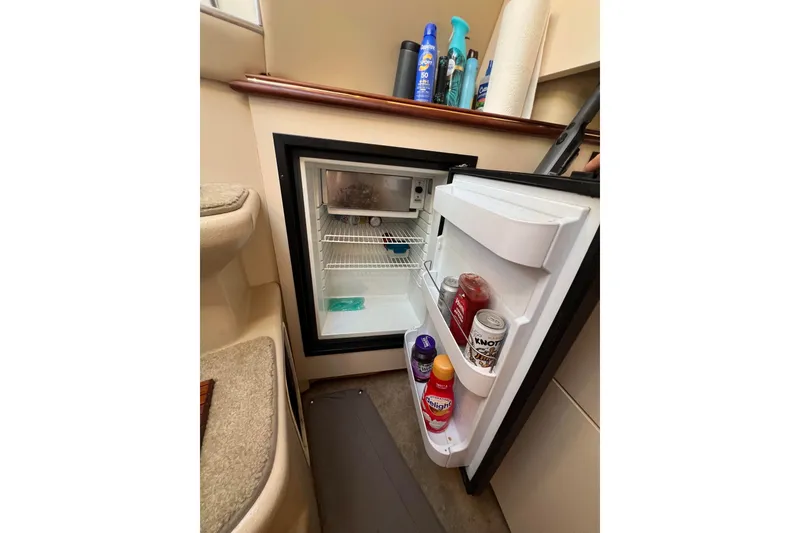 Slide: The Image of Mini fridge inside 2003 Cruisers Yachts 3372 Express, stocked with beverages and condiments. - 32
