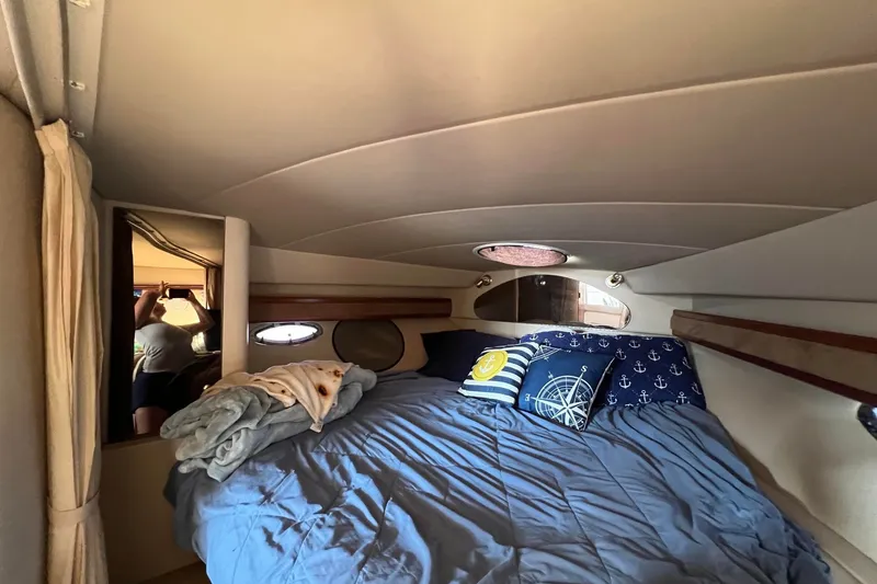 Slide: The Image of Cozy cabin interior of 2003 Cruisers Yachts 3372 Express with nautical-themed bedding. - 6
