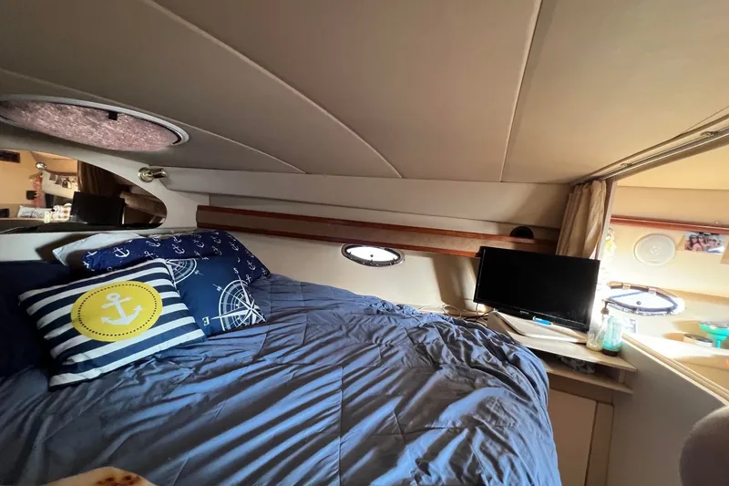 Slide: The Image of Cozy cabin interior of 2003 Cruisers Yachts 3372 Express with nautical-themed bedding. - 38