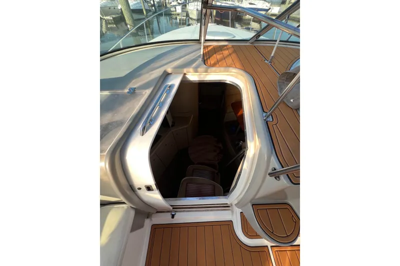 Slide: The Image of 2003 Cruisers Yachts 3372 Express cabin entrance with teak deck and stainless steel railings. - 46