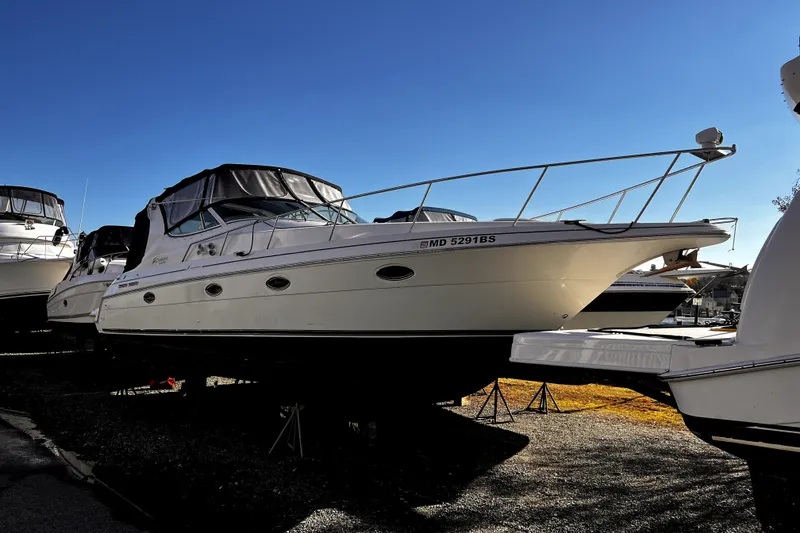 Slide: The Image of 2003 Cruisers Yachts 3372 Express boat on display under clear blue sky. - 25