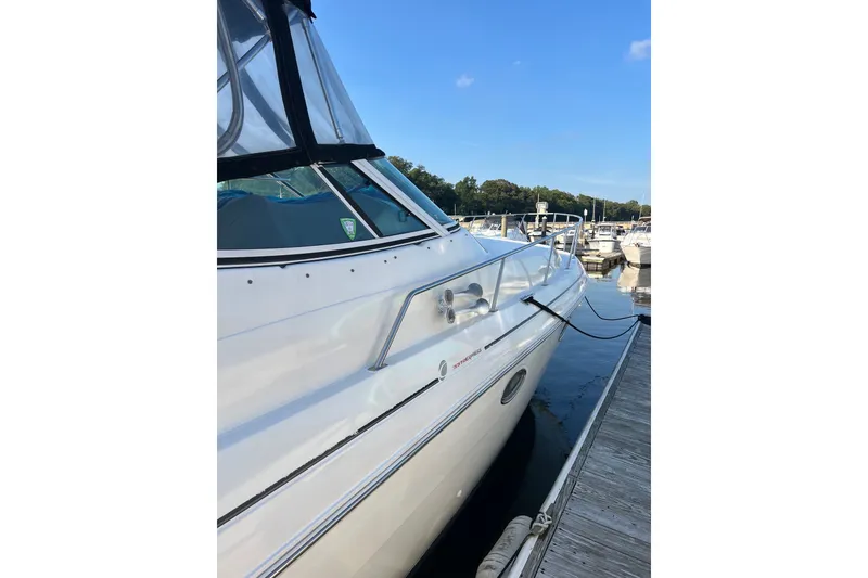 Slide: The Image of 2003 Cruisers Yachts 3372 Express docked at marina under clear blue sky. - 9