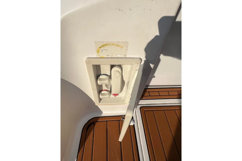 Slide: The Image of 2003 Cruisers Yachts 3372 Express deck detail with control panel and teak flooring. - 29