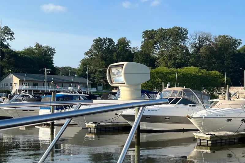 Slide: The Image of Marina with 2003 Cruisers Yachts 3372 Express, surrounded by other boats and lush greenery. - 8