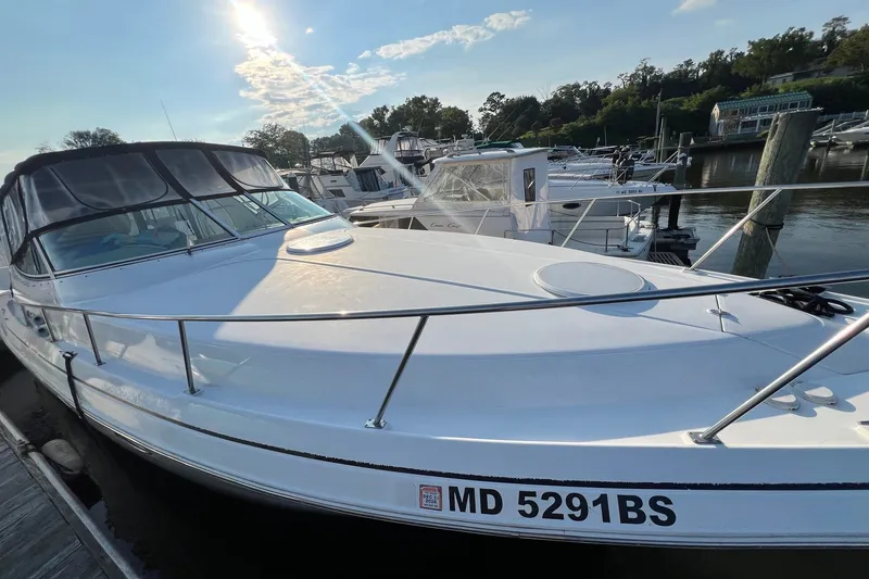 Slide: The Image of 2003 Cruisers Yachts 3372 Express docked at marina under sunny sky. - 14