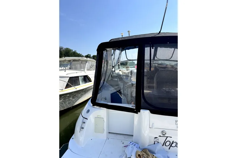 Slide: The Image of 2003 Cruisers Yachts 3372 Express docked, featuring rear view and covered seating area. - 28