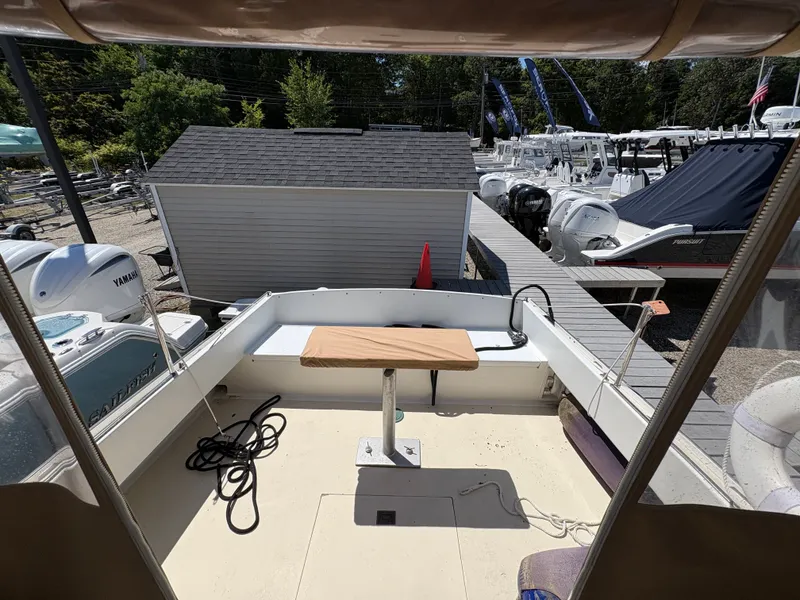Slide: The Image of The image shows the deck of a 1988 Jarvis Newman 32 boat docked at a marina. - 17