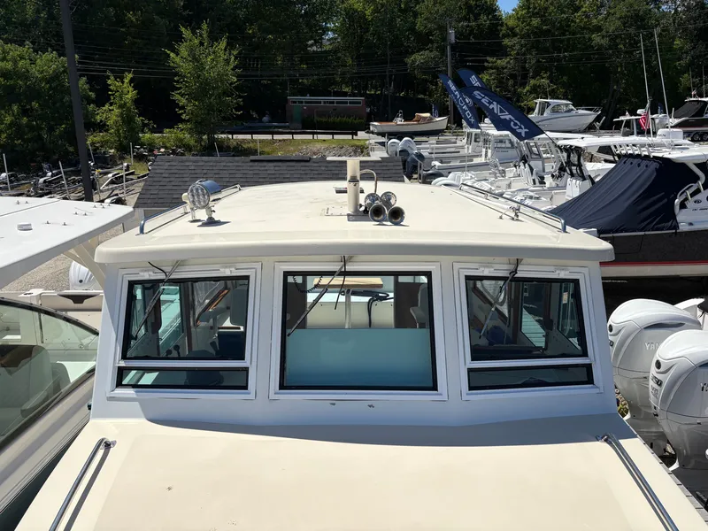 Slide: The Image of A 1988 Jarvis Newman 32 boat with a white cabin and multiple windows. - 25
