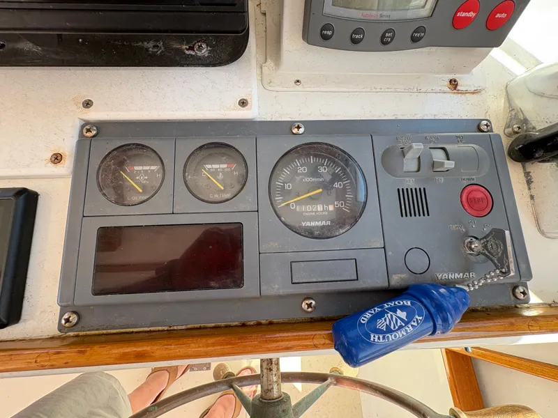Slide: The Image of The image shows a boat dashboard with various gauges and a blue keychain. - 14