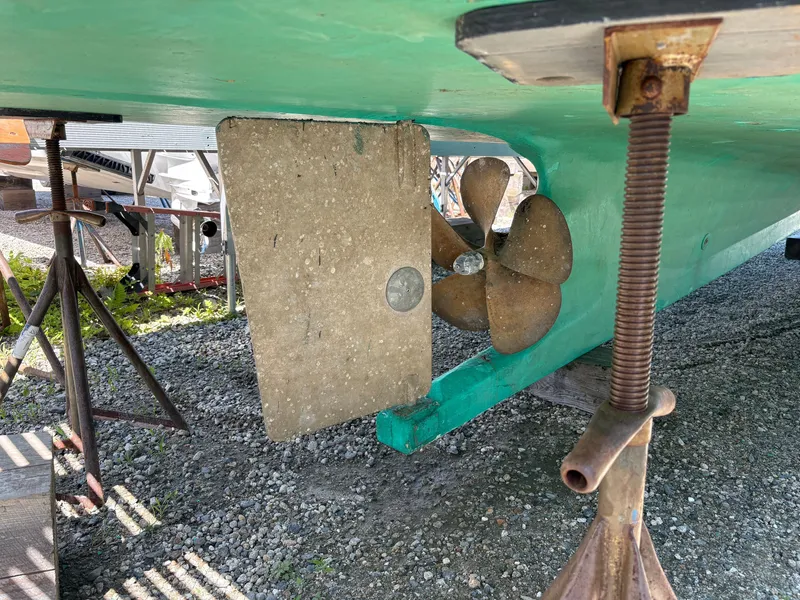 Slide: The Image of The image shows the underside of a boat with a propeller and rudder. - 27