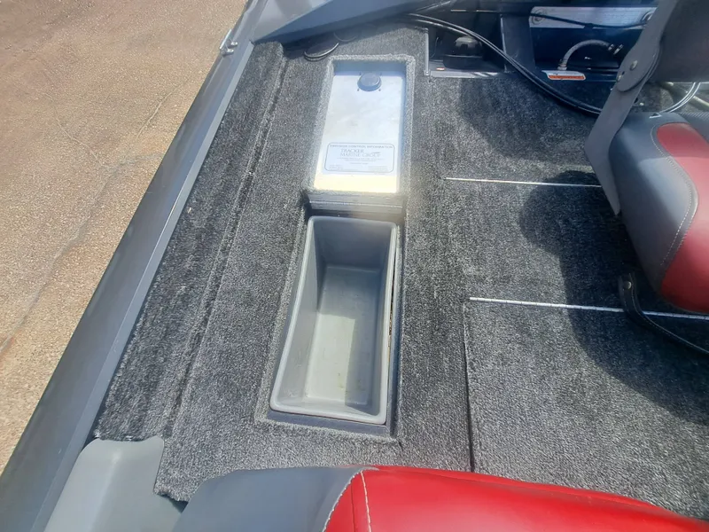 Slide: The Image of The image shows the interior of a 2014 Tracker Pro Team 190 boat with a storage compartment. - 14