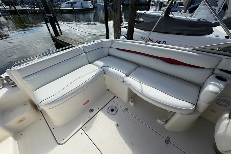 Slide: The Image of 2006 Monterey 248LS Montura Bowrider with white seating, docked at marina. - 19