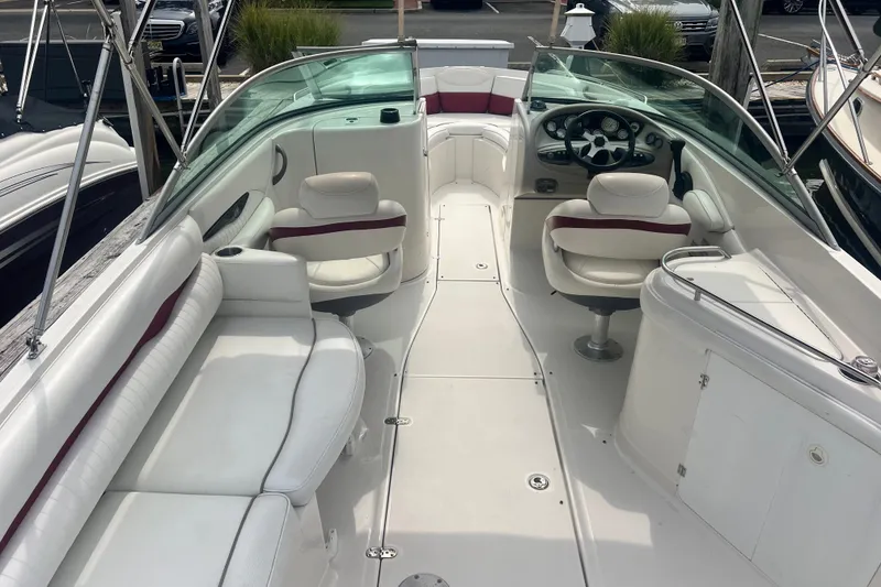 Slide: The Image of 2006 Monterey 248LS Montura Bowrider interior with white seating and steering console. - 8