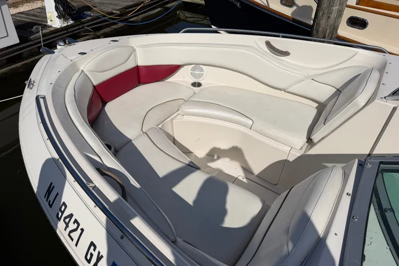 Slide: The Image of 2006 Monterey 248LS Montura Bowrider with white and red seating, docked at marina. - 15