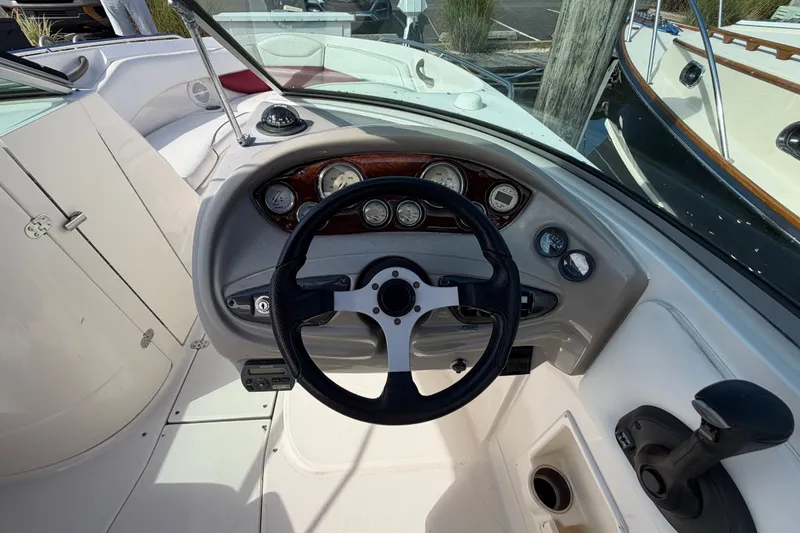 Slide: The Image of 2006 Monterey 248LS Montura Bowrider dashboard with steering wheel and gauges. - 23