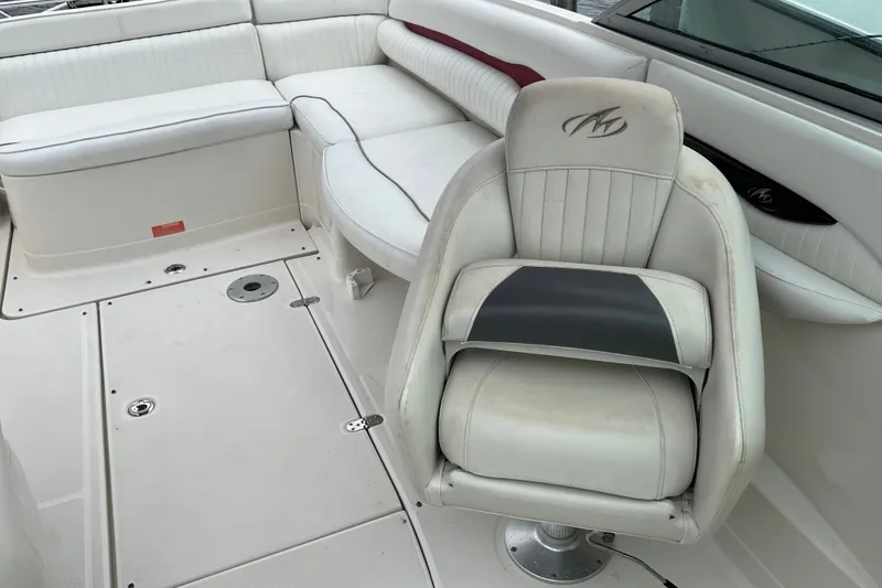 Slide: The Image of 2006 Monterey 248LS Montura Bowrider interior with white seating and helm chair. - 9