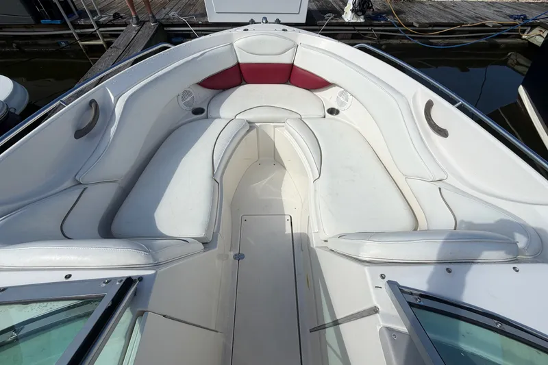 Slide: The Image of 2006 Monterey 248LS Montura Bowrider with spacious white seating and red accents. - 25