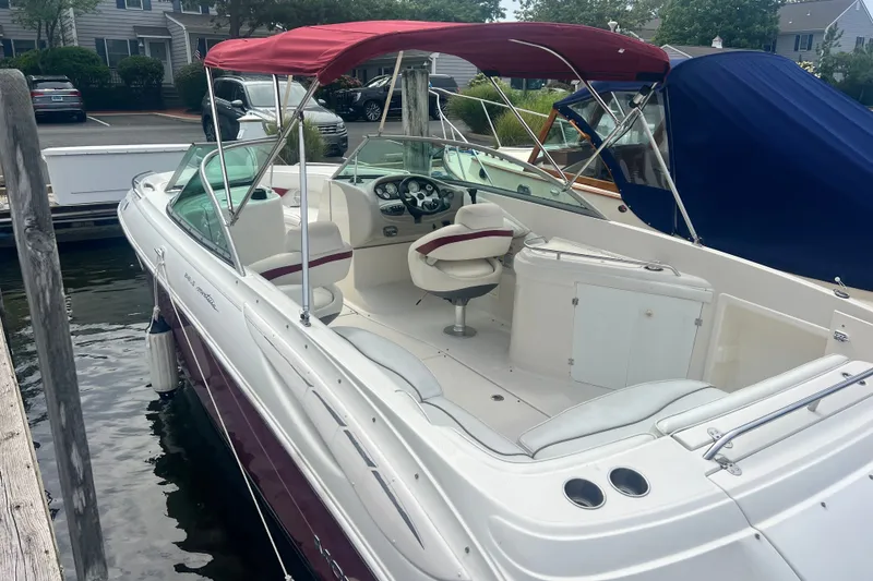 Slide: The Image of 2006 Monterey 248LS Montura Bowrider with red canopy docked at marina. - 7