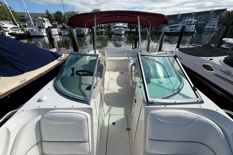 Slide: The Image of 2006 Monterey 248LS Montura Bowrider with red canopy docked at marina. - 26