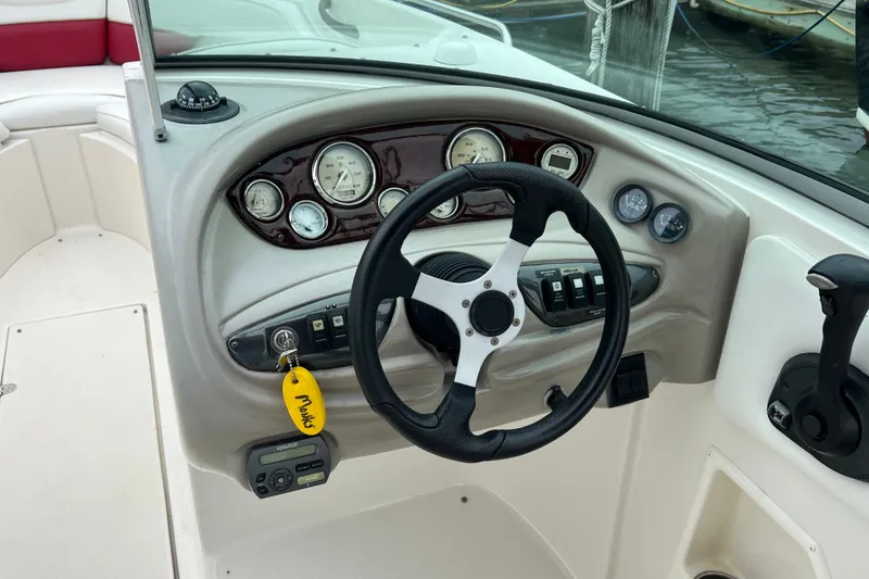 Slide: The Image of Steering console of a 2006 Monterey 248LS Montura Bowrider with gauges and controls. - 10
