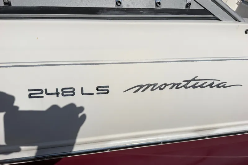 Slide: The Image of 2006 Monterey 248LS Montura Bowrider boat nameplate with shadow. - 28