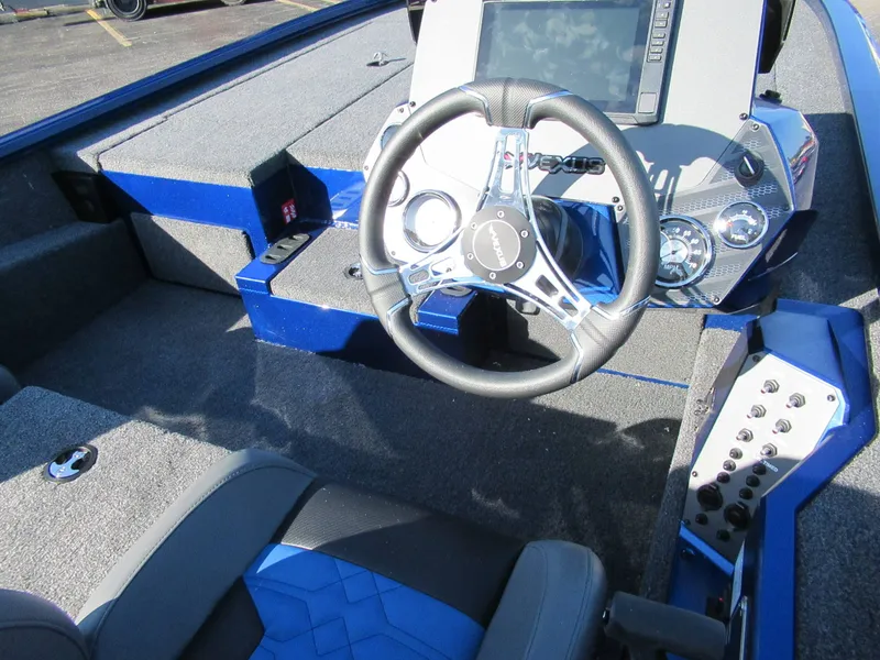Slide: The Image of The image shows the cockpit of a Vexus AVX 1980 boat with a modern steering wheel and instruments. - 5