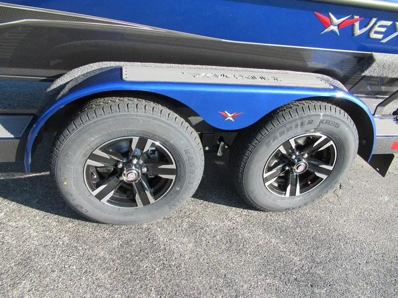 Slide: The Image of Close-up of a blue boat trailer with two black tires and silver rims. - 8