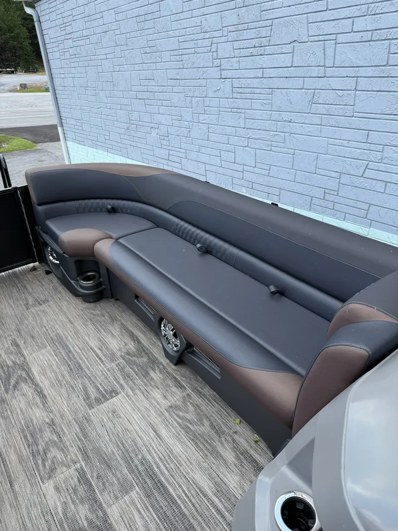 Slide: The Image of The image shows a sleek seating area on a boat, featuring gray and brown upholstery. - 15