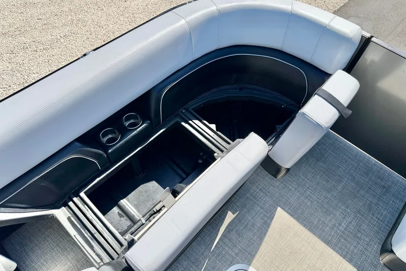 Slide: The Image of Luxurious seating area of 2027 Vanderbilt 23QS boat with storage and cup holders. - 22