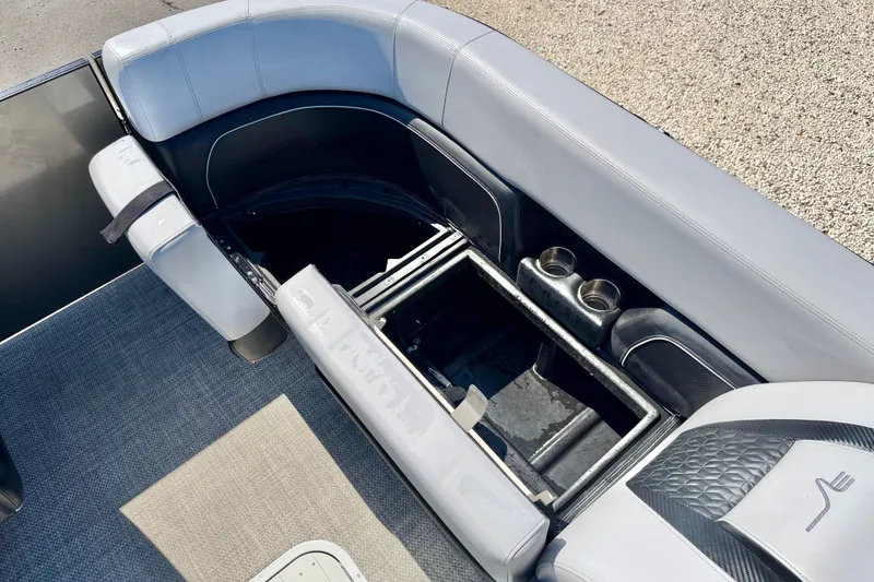 Slide: The Image of 2027 Vanderbilt 23QS boat interior with open storage compartment and cup holders. - 21