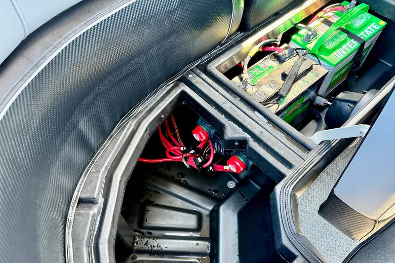 Slide: The Image of Battery compartment of a 2027 Vanderbilt 23QS boat, featuring Interstate batteries and wiring. - 29