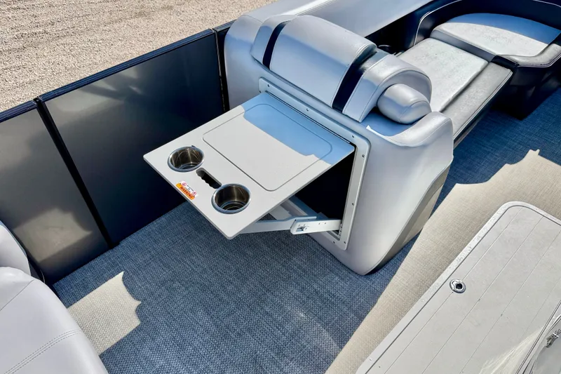 Slide: The Image of 2027 Vanderbilt 23QS boat interior with foldable table and cup holders. - 25