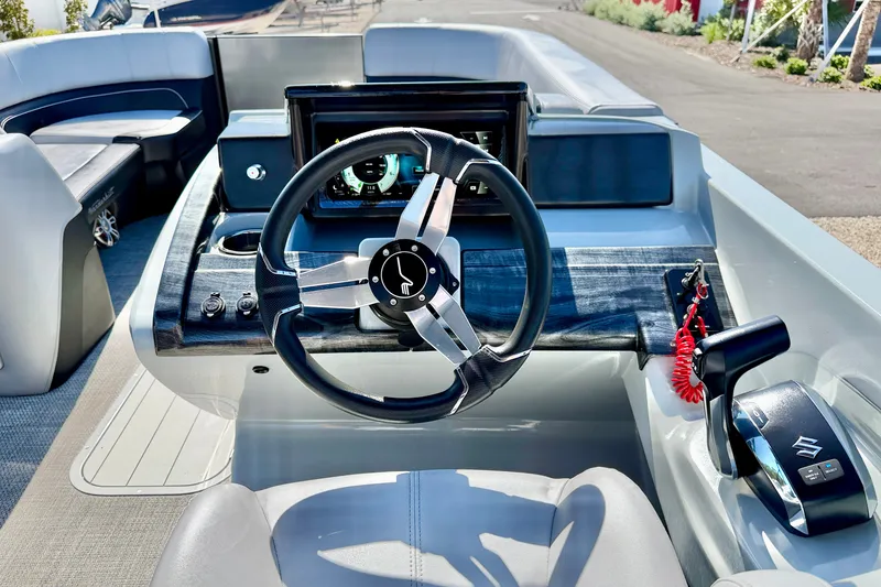 Slide: The Image of Steering console of a 2027 Vanderbilt 23QS boat with modern controls and dashboard. - 13